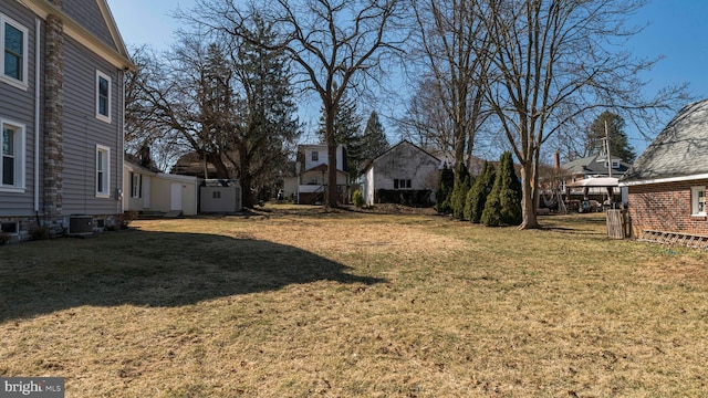 view of yard with a residential view and central AC