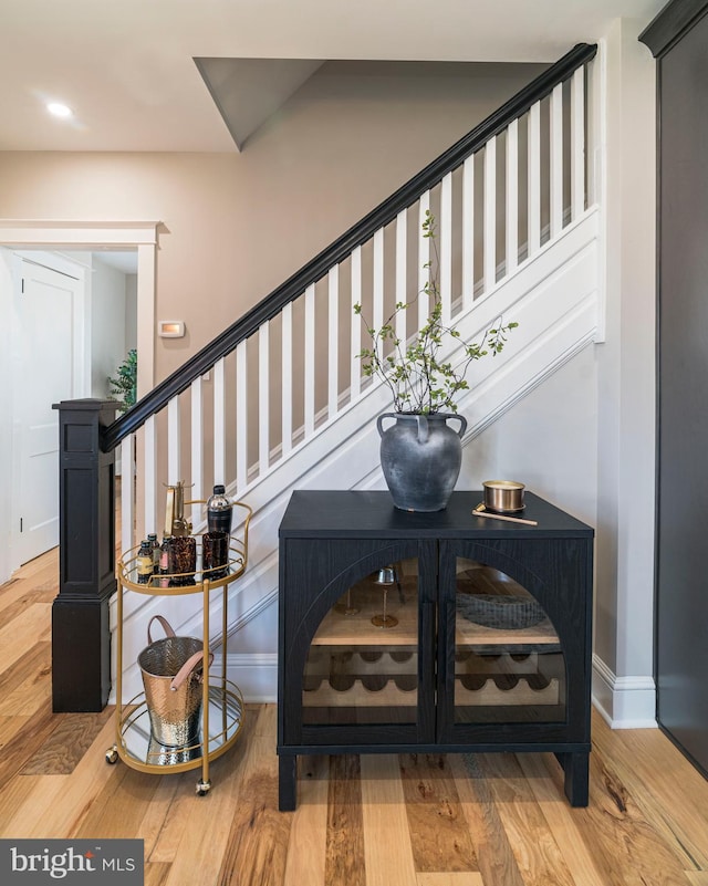 stairs featuring wood finished floors and baseboards