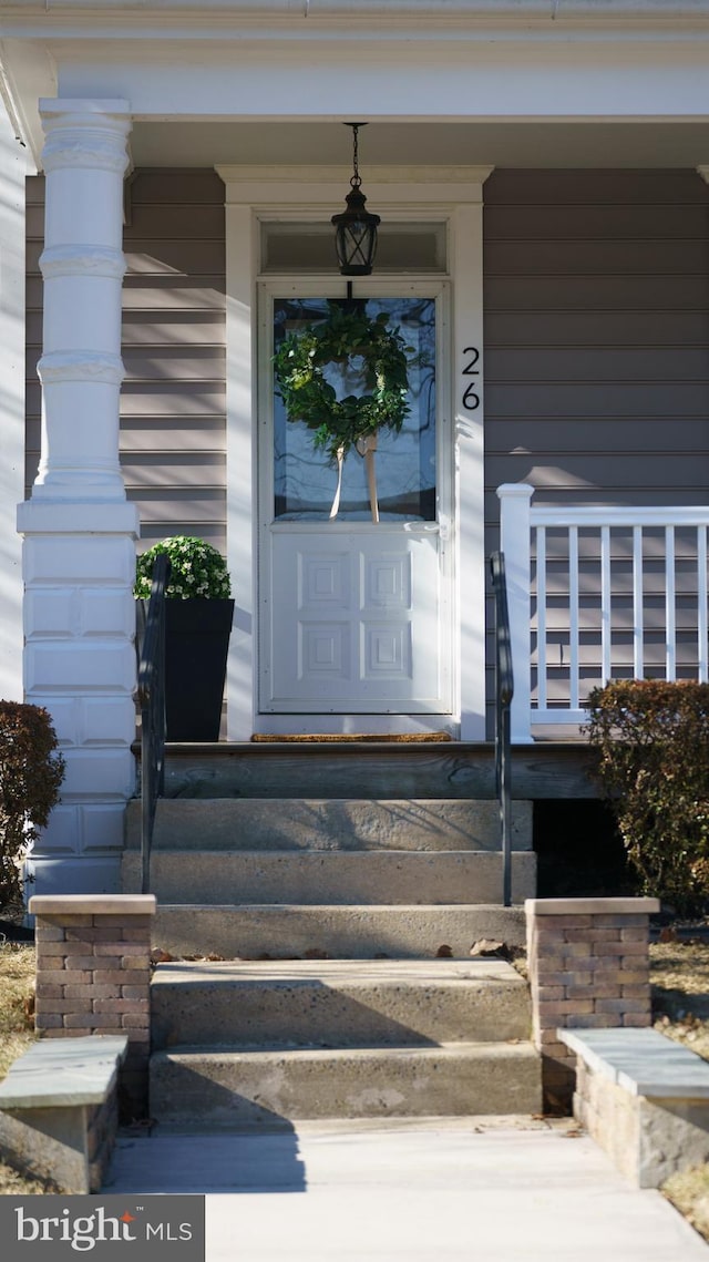 view of exterior entry featuring a porch