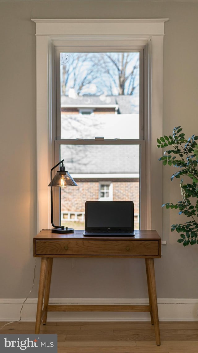 office space featuring baseboards and wood finished floors