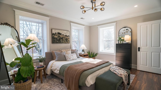 bedroom featuring multiple windows, visible vents, and ornamental molding