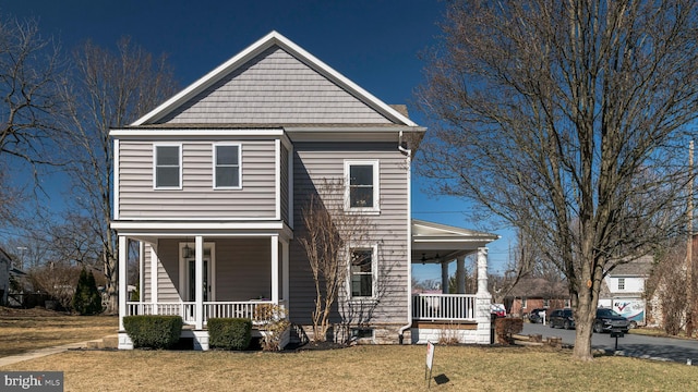 view of front facade with covered porch and a front yard