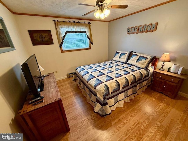 bedroom featuring a textured ceiling, ornamental molding, light wood-type flooring, and a baseboard radiator