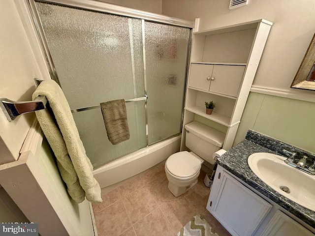 full bath with tile patterned flooring, toilet, visible vents, vanity, and combined bath / shower with glass door