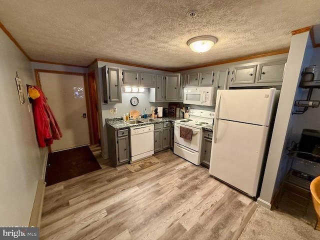 kitchen with white appliances, light wood-style flooring, crown molding, gray cabinetry, and a sink