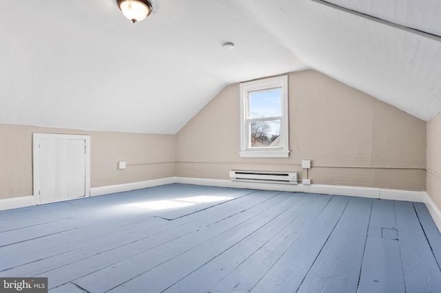 additional living space with hardwood / wood-style flooring, baseboards, a baseboard heating unit, and vaulted ceiling