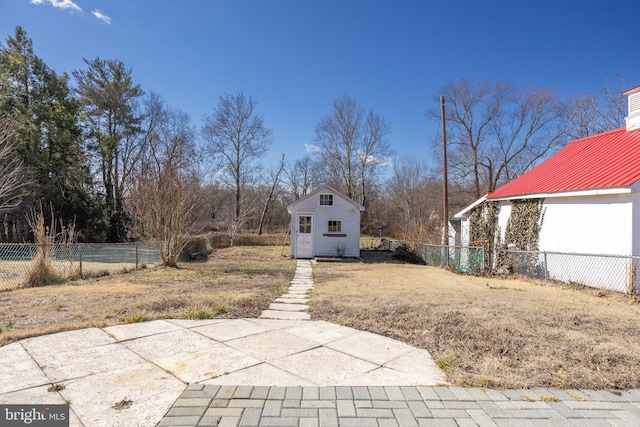 view of yard featuring an outdoor structure and fence