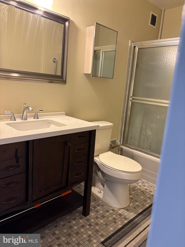 bathroom featuring tile patterned flooring, visible vents, toilet, and vanity