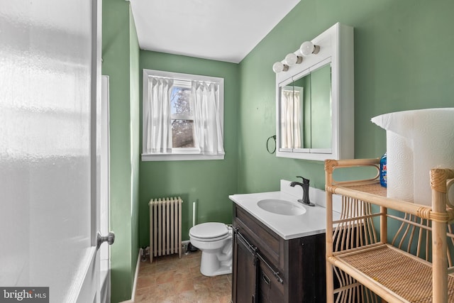 bathroom featuring radiator, toilet, and vanity