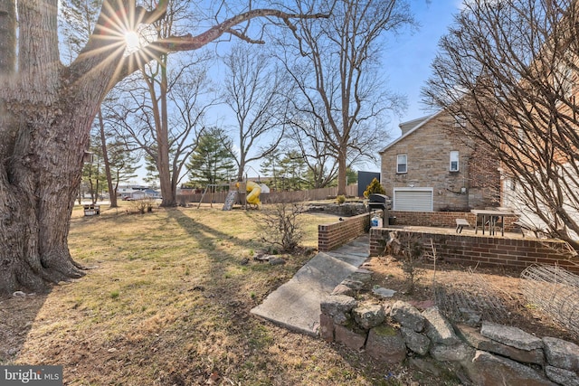 view of yard with a playground and fence