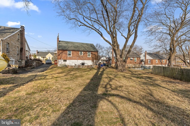 view of yard with a residential view and fence