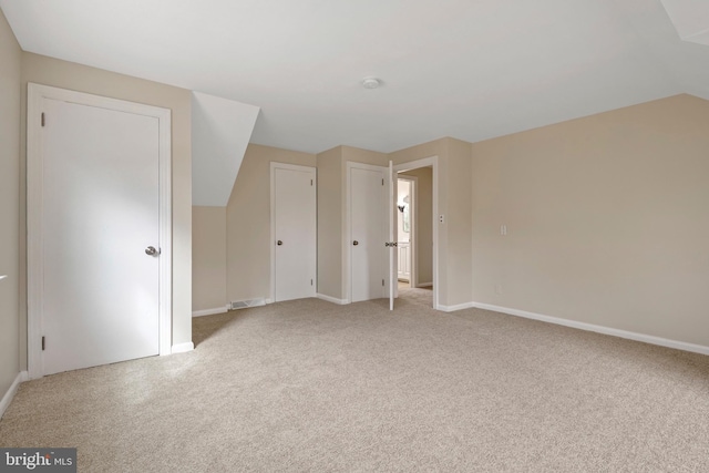 unfurnished bedroom with baseboards, visible vents, and light colored carpet