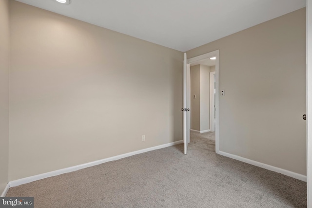 unfurnished bedroom featuring baseboards and carpet flooring