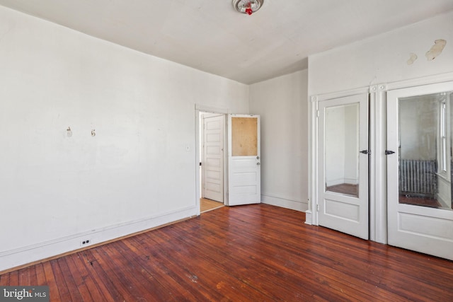 unfurnished bedroom with baseboards and hardwood / wood-style floors