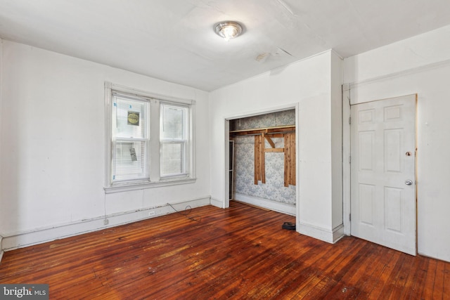 unfurnished bedroom with hardwood / wood-style floors and a closet