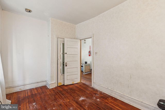 empty room with wood-type flooring