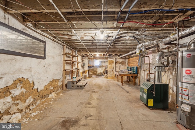 unfinished below grade area featuring a heating unit and gas water heater