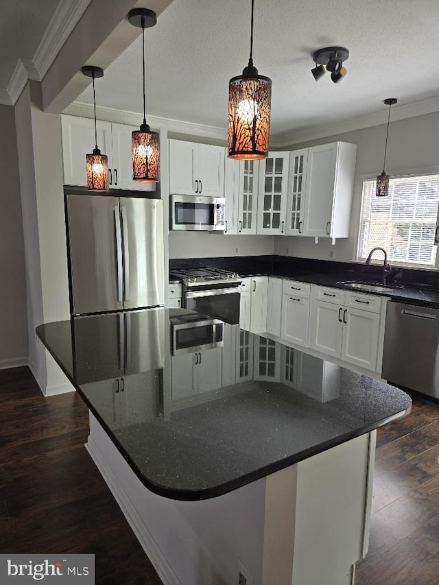 kitchen featuring ornamental molding, appliances with stainless steel finishes, dark wood-style floors, and glass insert cabinets