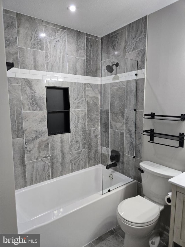 bathroom featuring marble finish floor, bathing tub / shower combination, vanity, and toilet