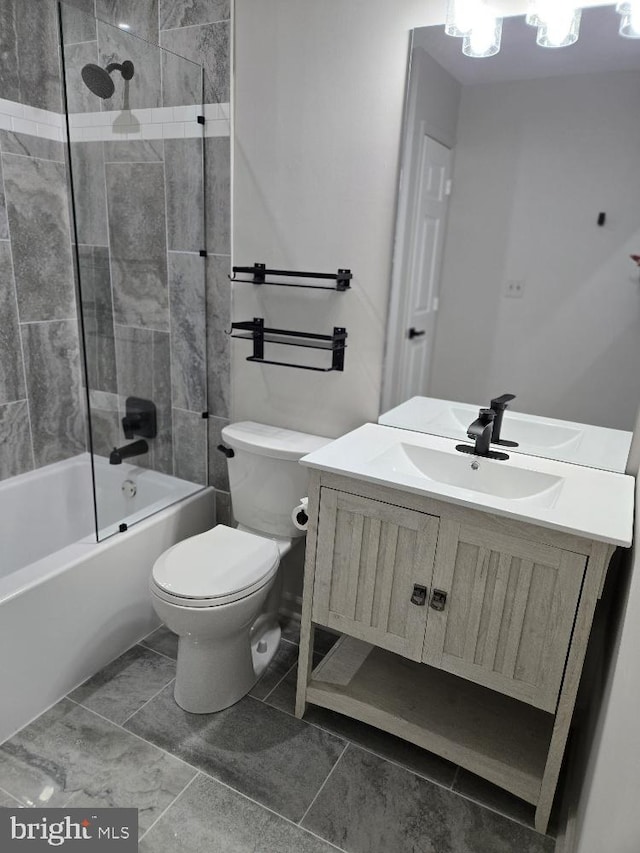 bathroom featuring washtub / shower combination, vanity, and toilet