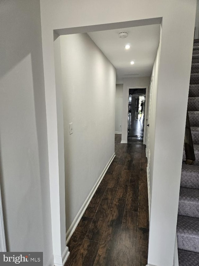 corridor with recessed lighting, baseboards, stairway, and hardwood / wood-style floors