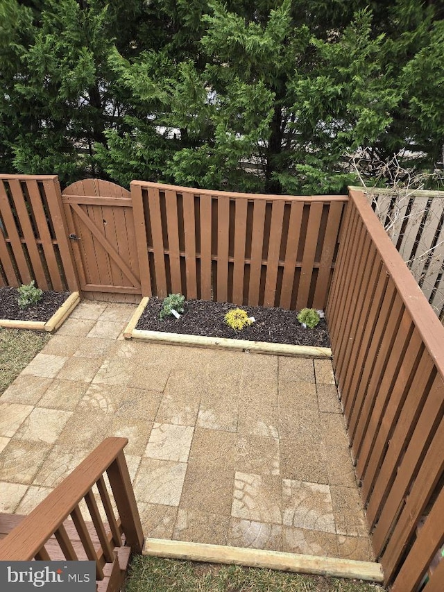 view of patio featuring a gate