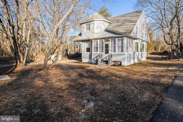 view of front of home featuring a shingled roof and entry steps