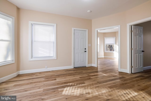 unfurnished room featuring baseboards and wood finished floors