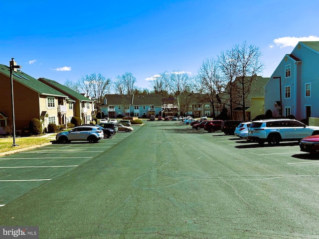 uncovered parking lot with a residential view