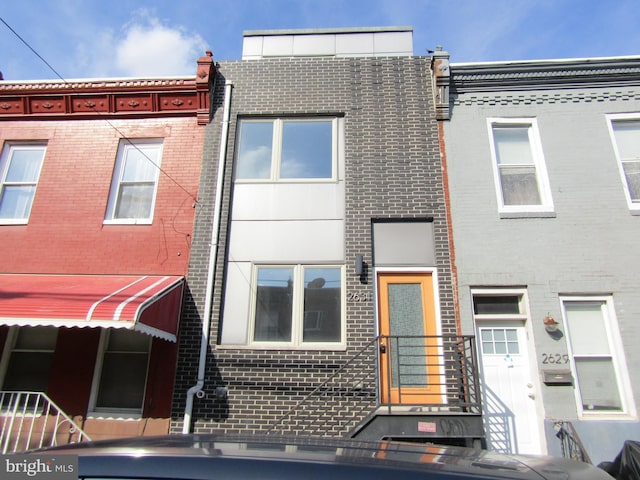 view of property featuring brick siding