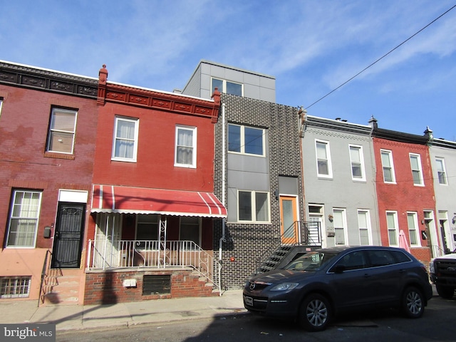 townhome / multi-family property featuring brick siding