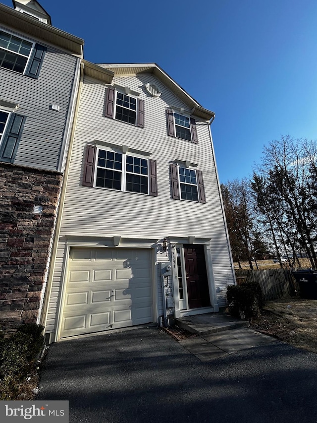 view of property featuring driveway and an attached garage