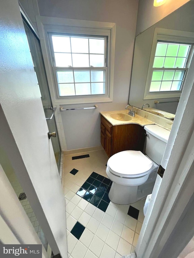 full bathroom with vanity, tile patterned flooring, a shower stall, and toilet