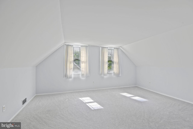 bonus room with visible vents, baseboards, vaulted ceiling, and carpet