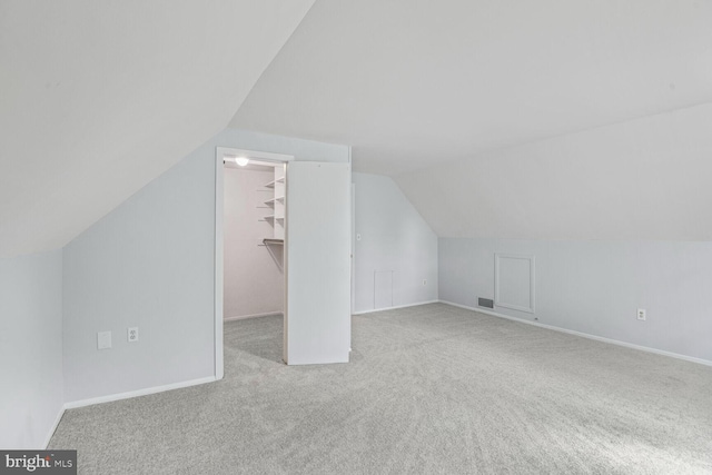 bonus room featuring visible vents, carpet flooring, baseboards, and lofted ceiling