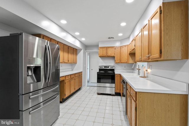 kitchen with light floors, recessed lighting, light countertops, a sink, and stainless steel appliances