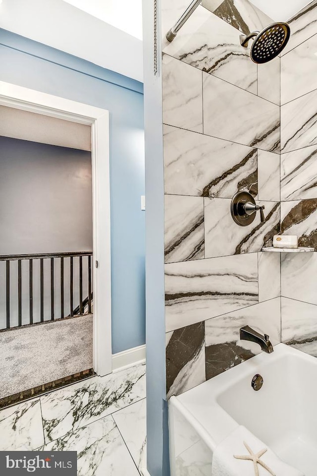 full bath featuring marble finish floor, tub / shower combination, and baseboards