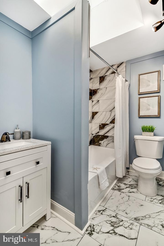 bathroom with toilet, a sink, baseboards, marble finish floor, and shower / tub combo with curtain