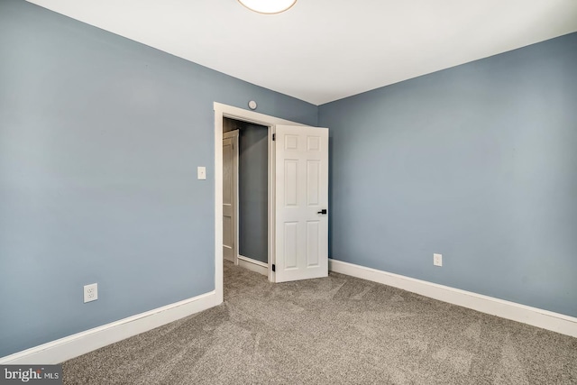 unfurnished bedroom with carpet and baseboards