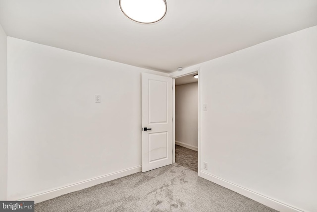 empty room with light carpet and baseboards