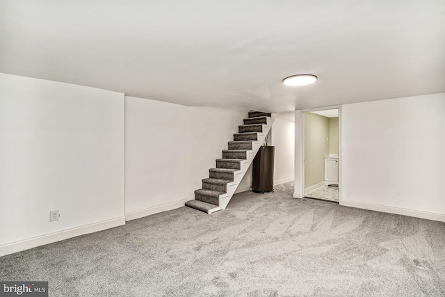 finished basement with stairs, carpet, and baseboards