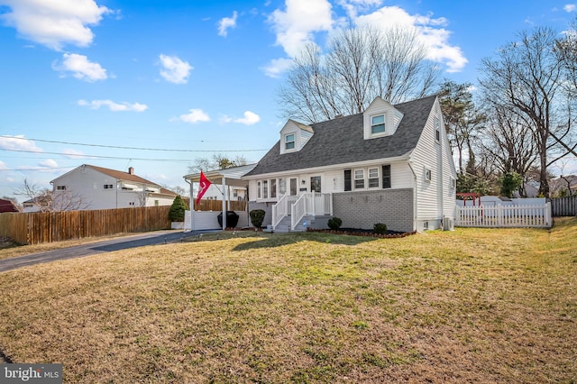 cape cod-style house with a front yard, brick siding, fence, and roof with shingles