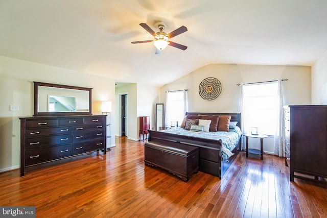 bedroom with lofted ceiling, a ceiling fan, dark wood-style flooring, and baseboards