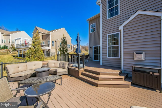 wooden deck with a residential view and an outdoor hangout area