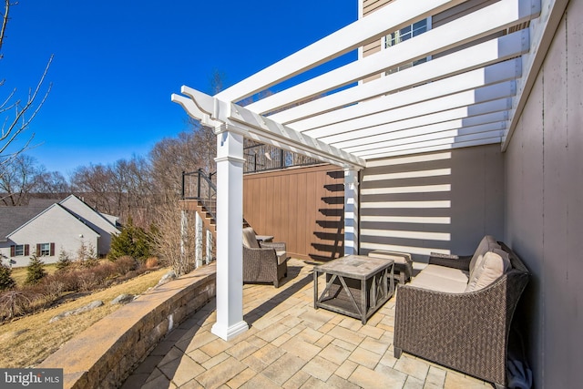 view of patio featuring stairs, an outdoor living space, and a pergola