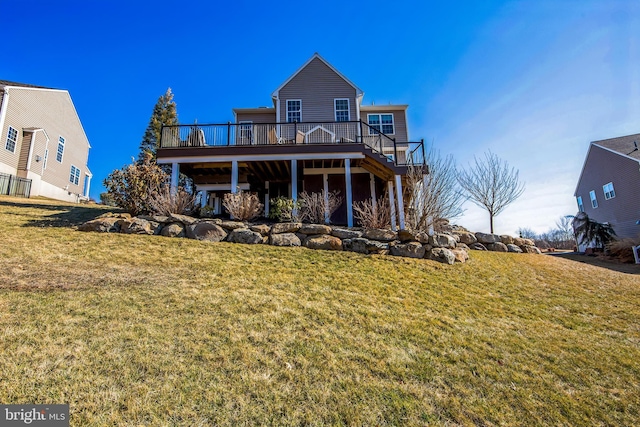 rear view of property with a yard and a wooden deck