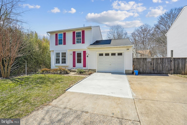 traditional home featuring an attached garage, concrete driveway, a front lawn, and fence