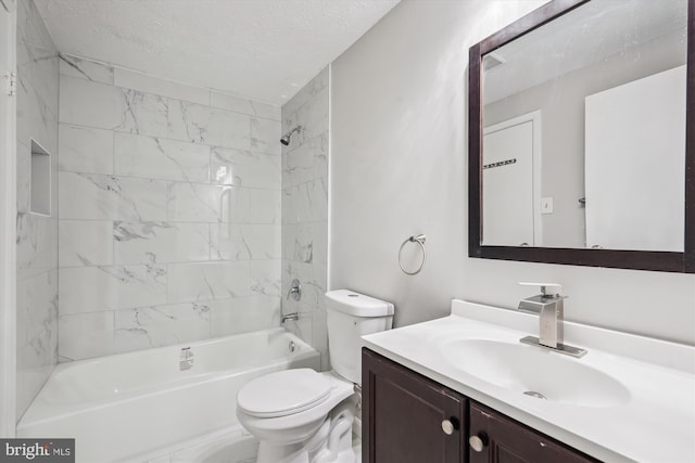 bathroom featuring toilet, a textured ceiling, vanity, and shower / bathing tub combination