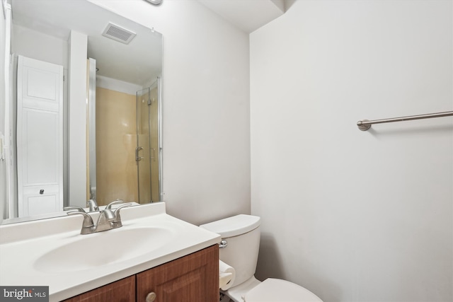 bathroom with visible vents, a shower, toilet, and vanity