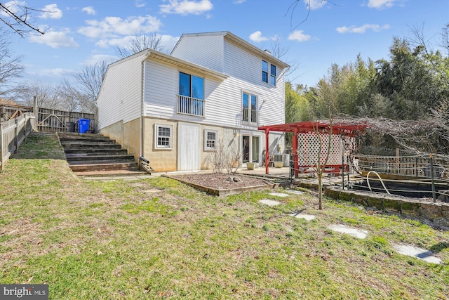 rear view of property with a yard, a patio area, a pergola, and a fenced backyard